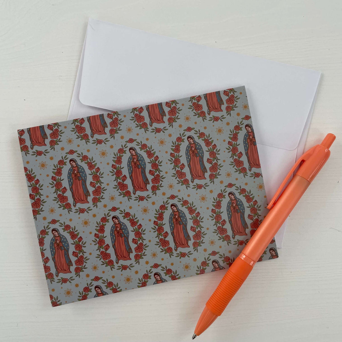 Guadalupe themed Catholic note card with matching envelope and orange pen, part of a 10-pack collection for handwritten notes.