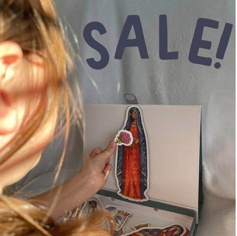 Child playing with Mama Mary Magnetic Dress Up Doll on sale, featuring Our Lady of Guadalupe outfit with magnetic accessories.