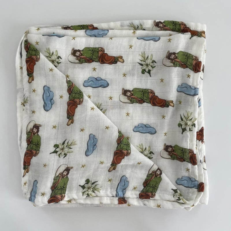Sleeping Saint Joseph Swaddle with devotional imagery and light blue clouds, inspired by Pope Francis's devotion, perfect for gifting.