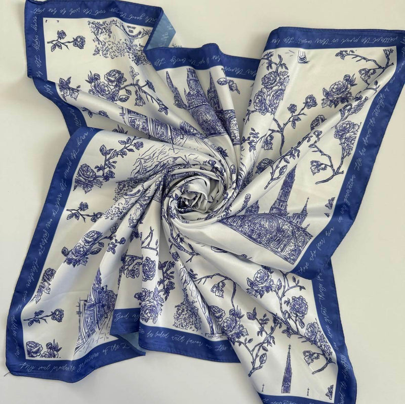 Elegant Catholic satin scarf from the Lourdes Collection featuring blue and white religious designs and floral accents.