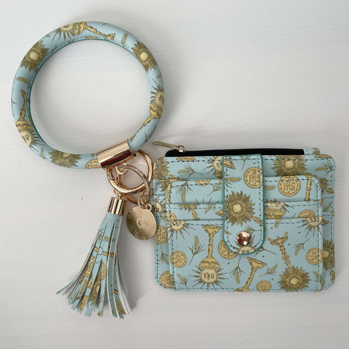 Catholic I.D. Wallet with Eucharistic pattern and tassel, featuring a faux leather strap and gold charms, 4.75x4 inches.