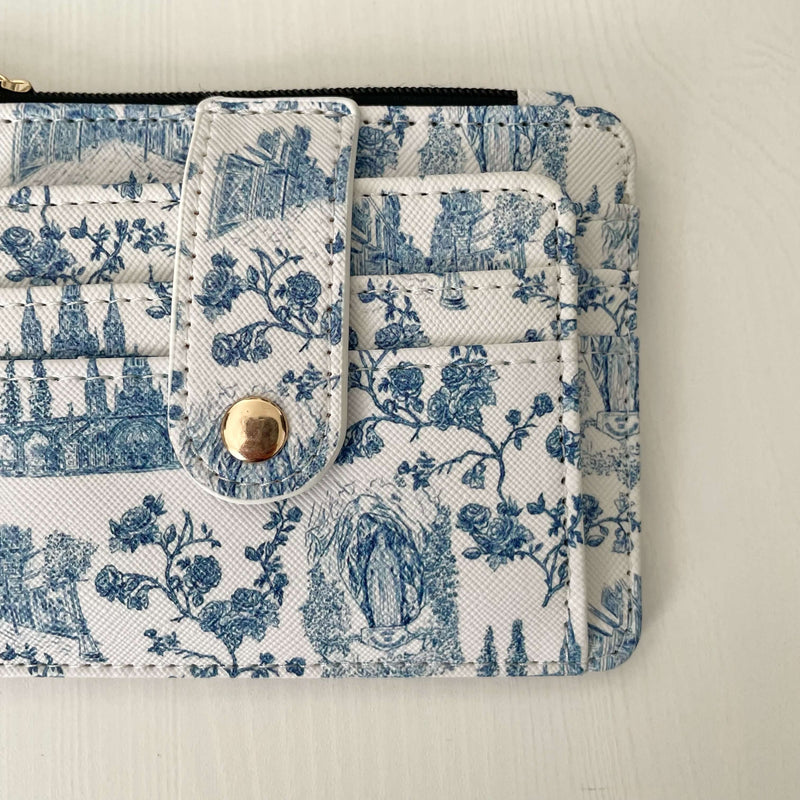 Catholic ID wallet from the Lourdes Collection in faux leather with a blue floral and religious motif, stylish and durable.
