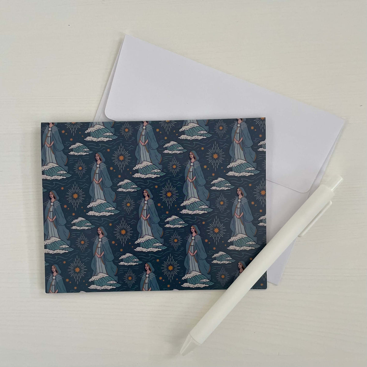 Catholic note card with Stella Maris design, envelope, and pen on white background.