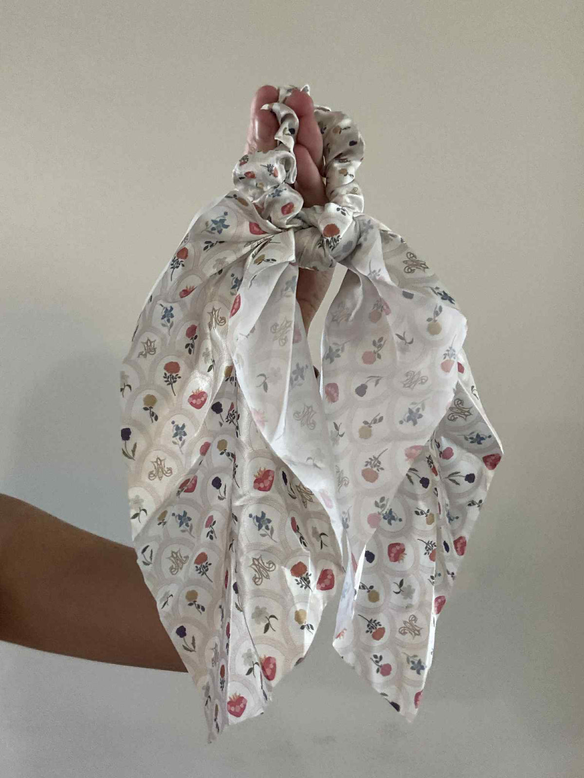 Catholic satin hanging scrunchie with floral patterns from Mary's Sacred Garden Collection, showcasing timeless and feminine ribbon design.