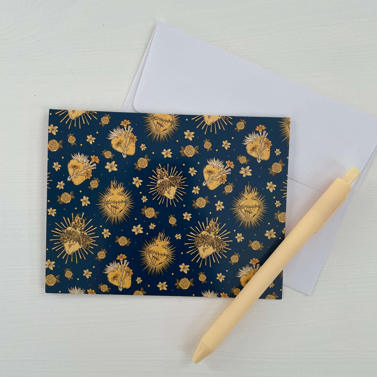 Catholic note card with Holy Hearts pattern, navy and gold design, paired with envelope and pen, part of 10-pack collection.