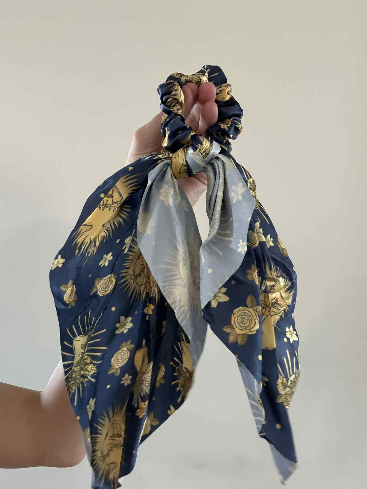 Catholic Satin Hanging Scrunchie with Holy Hearts print, navy and gold floral pattern, timeless and feminine hair accessory.