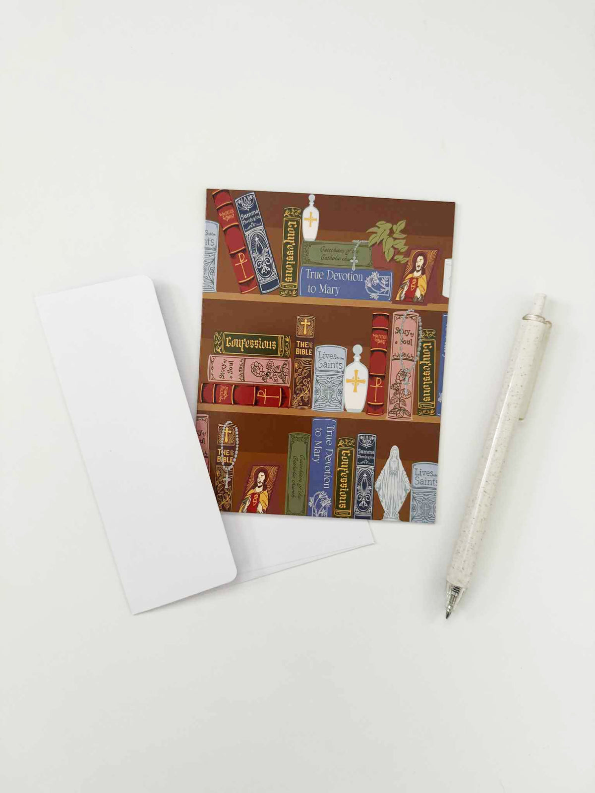 Catholic note card featuring library collection theme with pen and blank card, part of a pack of 10. Perfect for personal messages.