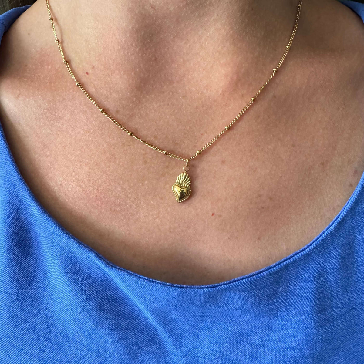 18k gold plated Sacred Heart of Jesus necklace on woman, 18-inch chain, dainty faith symbol accessory.