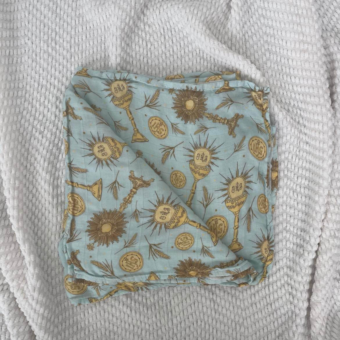 Eucharistic swaddle blanket with religious symbols and soft bamboo cotton fabric, 47x47 inches, perfect for babies.