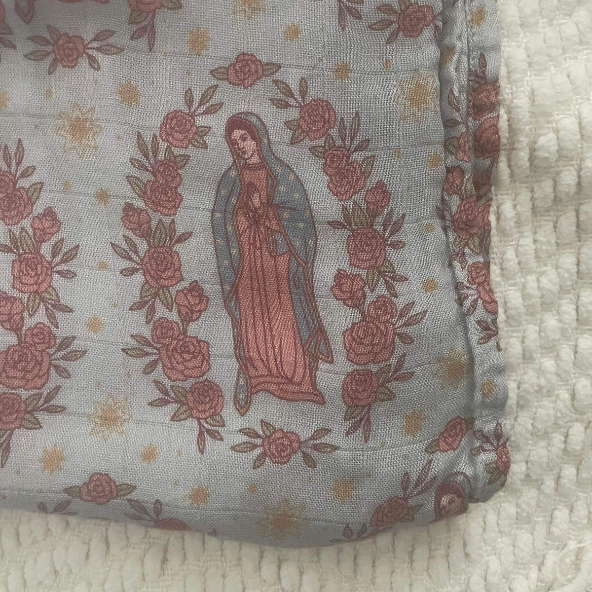 Guadalupe swaddle blanket with religious pattern featuring Our Lady of Guadalupe, made from organic bamboo cotton, 47x47 inches.