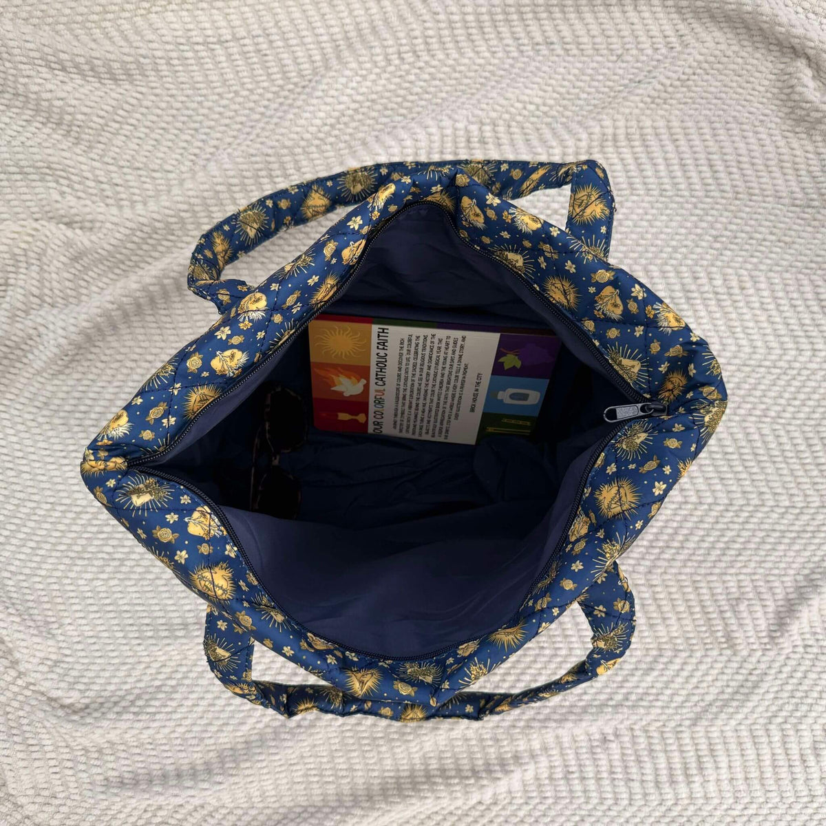 Open Holy Hearts Quilted Bag with floral design, showcasing spacious interior and wide zipper opening, perfect for essentials.