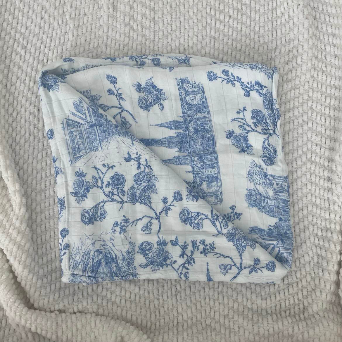 Lourdes Swaddle Blanket with blue floral and religious design on soft 100% organic bamboo cotton, 47x47 inches.