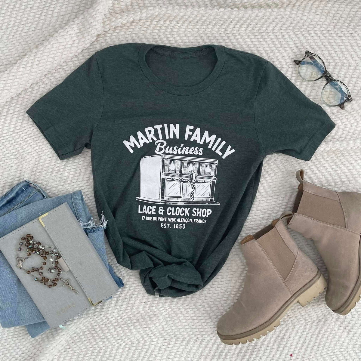 Martin Family Business tee featuring lace and clock shop illustration, honoring Zelie and Louis Martin's legacy of faith and entrepreneurship.