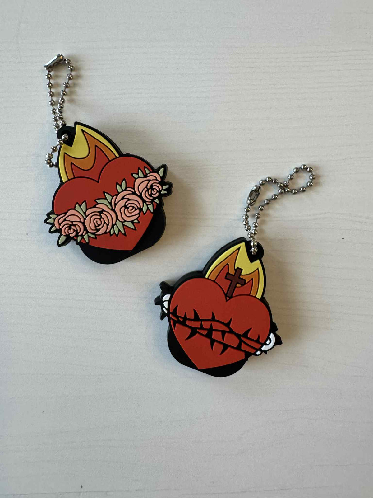 Sacred Heart and Immaculate Heart key caps with chain, symbolizing love and protection in flexible silicone material.
