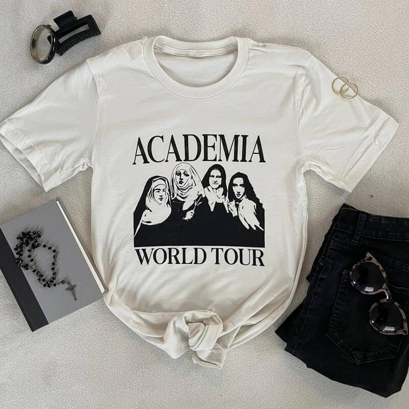 Academia World Tour Tee featuring female doctors of the Catholic Church with black jeans and accessories.
