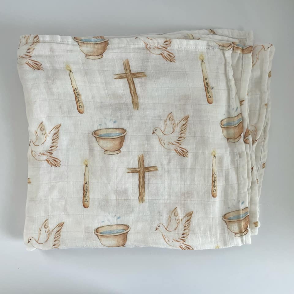 Baptism swaddle blanket with religious symbols including doves, crosses, and candles for a holy sacrament celebration.