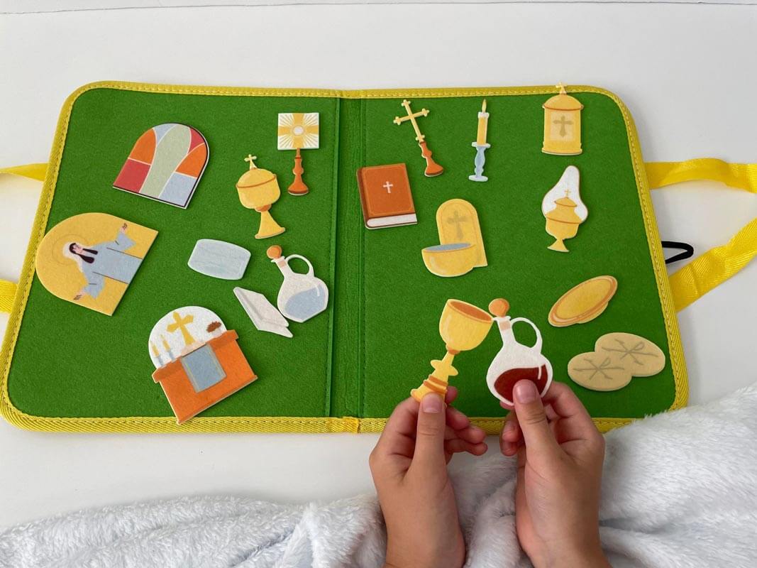 Child playing with Catholic Mass Felt Book Kit to learn about church rituals; portable educational toy for kids.