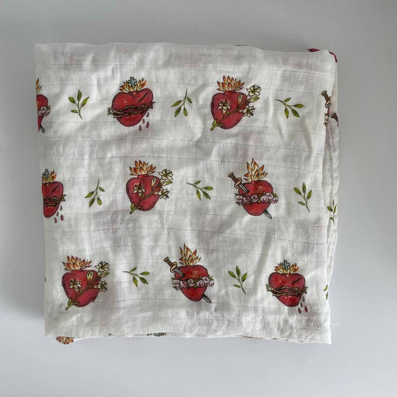 Holy Family Hearts Swaddle Blanket featuring Sacred Heart, Immaculate Heart, and Chaste Heart designs.