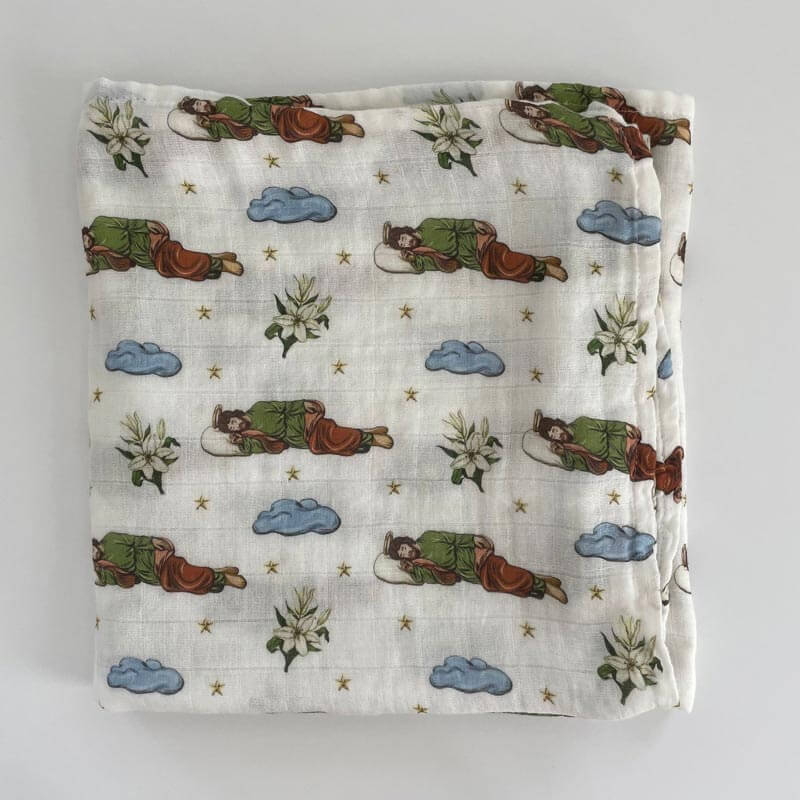 Sleeping Saint Joseph Swaddle with illustrated prints for devotion and comfort inspired by Pope Francis.